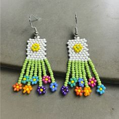 two pairs of beaded earrings with flowers on them