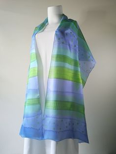 ", silk wrap blue, silk scarf, personalized gift for woman, original silk art accessory  I created this long silk shawl using the freehand painting technique, using blue, green, and turquoise shades spilled color lines on white silk with a touch of gold. Colors blend freely into each other and create a subtle shining pattern with the mood of a clear summer sky. Small drops of gold on the smooth surface of the scarf make an impression of golden mist and a sense of luxury. This cool silk wrap is a Elegant Hand Painted Blue Silk Scarf, Elegant Blue Hand Painted Scarves, Elegant Hand Painted Blue Scarves, Artistic Blue Silk Scarves, Blue Hand Painted Silk Scarf, Blue Silk Scarf For Spring, Summer Blue Silk Scarf, Hand Painted Blue Silk Scarf For Gift, Hand Painted Blue Silk Scarf For Summer