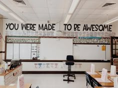 an empty classroom with desks and whiteboards on the wall that say you were made to be awesome