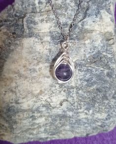 Immerse yourself in the enchanting beauty of the Handmade Silver Natural Amethyst Crystal Herringbone weave Pendant. Crafted with care and attention to detail, this pendant showcases a beautiful herringbone weave pattern carefully crafted from fine metal wire, such as sterling silver or silver plated copper.  The chain depicted in the image is measuring 45mm and it is made of stainless steel for the time being. Lavender Wire Wrapped Jewelry For Gifts, Handmade Lavender Crystal Necklaces Gift, Lavender Wire Wrapped Necklace For Gift, Handmade Lavender Crystal Necklace Gift, Handmade Lavender Crystal Pendant Necklace, Artisan Purple Hand Wrapped Jewelry, Handmade Lavender Teardrop Jewelry, Artisan Hand Wrapped Purple Jewelry, Purple Artisan Hand-wrapped Jewelry