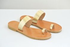 A minimal design that never goes out of style, these sandals are both fun/comfortable/versatile and fashionable. * Finest Quality Leather Genuine leather that comes from the island of Crete and it is famous for it's superior quality and uniqueness is picked one by one for our leather sandals. Ancient greek sandals were inspired and first created there. * Flexible Vibram Soles The soles used for our sandals are handmade completely in our family workshop ! They way we produce them is officially pa Modern Gold Open Toe Sandals, Minimalist Single Toe Strap Sandals For Spring, Chic Gold Open Toe Sandals, Modern Toe Ring Sandals For Beach And Summer, Modern Toe Ring Sandals For Summer Beach, Modern Toe Ring Sandals For Summer, Modern Toe Ring Sandals With Single Strap For Summer, Modern Open Toe Toe Ring Sandals For Summer, Chic Gold Toe Ring Sandals For Spring