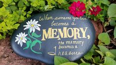 a memorial stone with flowers on it and the words, when someone you love become a memory, the memory becomes a dream