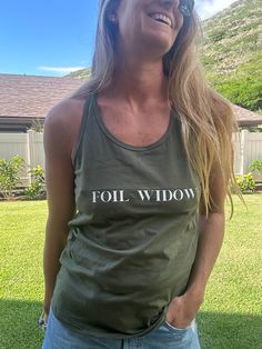 Let the wind feel the Foil Widow racer back tank! This cotton tank is designed to keep you cool, looking stylish, and feeling awesome. Perfect for a beach run or just chilling in the sun! 100% cotton graphic printed racer back tank top Casual Racerback Tank Top With Letter Print, Athleisure Cotton Tank Top With Graphic Print, Cotton Letter Print Tank Top Athleisure, Casual Cotton Racerback Tank Top, Trendy Racerback Cotton Tank Top, Cotton Graphic Print Racerback Tank Top, Trendy Cotton Racerback Tank Top, Cotton Screen Print Racerback Tank Top, Moisture-wicking Cotton Tank Top