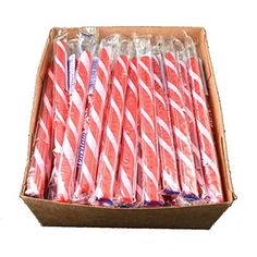 pink and white striped paper straws in a cardboard box with clear plastic wrappers