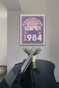 a black piano in front of a poster on the wall