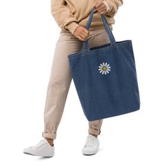 Discover the perfect blend of sustainability and botanical elegance with our Organic Denim Tote Bag, adorned with beautiful daisies. Crafted from high-quality organic denim, this tote promises durability and eco-friendly fashion.  Elevate your accessory collection with the option to embellish your tote with charming daisy embroidery, showcasing a personalized touch that transforms it into a distinctive statement piece or a considerate gift. Ideal for daily use, shopping, or as a stylish statemen Daily Use Embroidered Blue Canvas Bag, Multicolor Embroidered Cotton Tote Shoulder Bag, Multicolor Embroidered Tote Shoulder Bag, Multicolor Floral Embroidery Tote Shoulder Bag, Multicolor Floral Embroidered Tote Shoulder Bag, Daisy Embroidery, Embroidered Tote Bag, Embroidered Tote, Denim Tote Bags