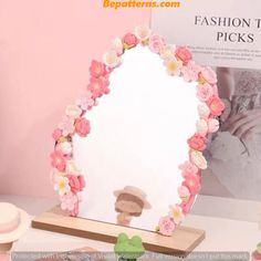 there is a mirror with flowers on it next to cupcakes and other items