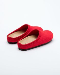 Description: The Nebraska Women's Wool Clog is an Italian take on a European classic. The women's Nebraska in red is one of the most versatile mule style slippers available. From home to the office to weekend, the minimalist design of these clogs will take you anywhere in comfort. The anatomical self-molding latex and thermoforming cork insole provide a firm customized comfort, and the insole is completely removable. LeClare Slippers are exclusively handcrafted in our small-batch factory in Trev Slip-on Indoor Clogs, Indoor Closed Toe Clogs With Cushioned Footbed, Red Casual Mules With Rubber Sole, Casual Red Mules With Rubber Sole, Solid Color Closed Toe Clogs With Cushioned Footbed, Closed Toe Clogs With Cushioned Footbed, Red Round Toe Slippers For Indoor Use, Clogs With Rubber Sole And Round Toe, Red Slip-on Mules With Rubber Sole