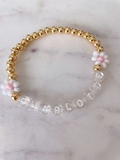 This listing is for your choice of an adult or child custom name bracelet with the daisy's as seen on bracelet. If you would prefer a different color letterbead please just message me so I can send you pictures of what I have. You will also be able to choose between gold-filled or gold-plated beads. The difference is the quality and will reflect in the price. The beads look the same but gold-filled can be worn in water and will not tarnish over time. For accurate measuring, please make sure to t Cute Personalized Gold Stretch Bracelet, Customizable White Name Bracelet, Personalized Cute Gold Beaded Bracelets, Trendy White Beaded Bracelets With Name, Cute Gold Name Bracelet For Friendship, Customizable White Charm Bracelet For Friendship, Personalized White Charm Bracelet For Everyday, White Custom Charm Bracelet For Friendship, Personalized White Charm Bracelet