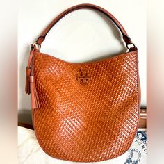 Tory Burch, Thea Woven Bucket Hobo Handbag, Camel Leather Woven And Suede Accents, Excellent Used Condition, Does Have Small Spot On The Bottom, Perfect For Fall! Designer Tan Bag With Braided Handles, Designer Tan Bags With Braided Handles, Tan Woven Leather Bag For Everyday Use, Tan Shoulder Bag With Braided Handles For Errands, Tan Bag With Braided Handles For Errands, Tan Bags With Braided Handles For Errands, Luxury Tan Shoulder Bag With Braided Handles, Elegant Tan Bags With Braided Handles, Tan Woven Leather Travel Bag