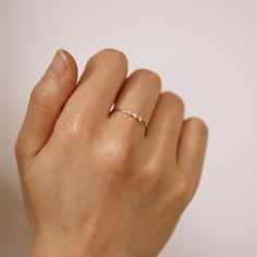 a woman's hand with a diamond ring on it