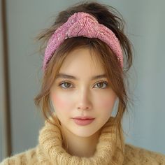 a woman wearing a pink knitted headband