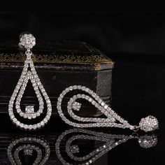 Stunning and elegant diamond drop earrings.Item #JP-E0021Metal: 14K White GoldWeight: 9.9 GramsDiamond Weight: Approx. 4 ctDiamond Color: HDiamond Clarity: SI1Measurements: 44.85 x 18.74 mmLayaway: For your convenience, we will be happy to provide layaway payment options. Please contact us to work out a layaway plan which best suits your needs. All layaway purchases are final sale.All domestic and international shipments are shipped with FedEx insured with signature required. International Shipm Luxury Teardrop Bridal Earrings For Formal Occasions, Elegant Sparkling Diamond White Diamond Earrings, Luxury Drop Diamond Earrings With Elegant Design, Glamorous Brilliant Cut Diamond White Earrings, Timeless Evening Bridal Earrings With Cubic Zirconia, Glamorous Diamond Bridal Earrings With Brilliant Cut, Sparkling Diamond Bridal Earrings, Glamorous Bridal Earrings, Diamond With Brilliant Cut, Luxury Sparkling Diamond Earrings For Formal Occasions