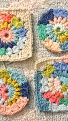 four crocheted squares with colorful flowers on them are arranged in the shape of circles