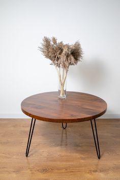 a wooden table with some dried flowers on it