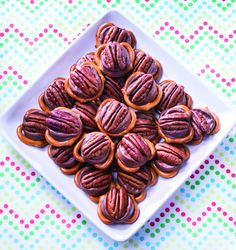 a white plate topped with chocolate covered pretzels