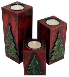 three wooden boxes with candles in them and a christmas tree painted on the inside one