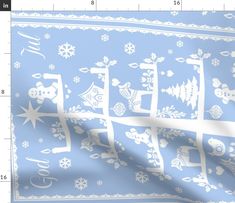 a blue and white bandana with snowflakes on it, in front of a ruler