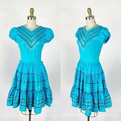 Item description: 1950s turquoise with black and silver rick rack patio fiesta dress with a very full skirt, princess sleeves and elastic waist. Dress is in great condition Original tag attached: Holiday Material: Cotton Holes: faint seam pop on back of dress about half an inch Stains: no Snags or runs in fabric: no Color fading: no Odor: no Attached buttons: n/a Working zipper: yes back nylon painted zipper Pockets: no Measurements: NOTE: these measurements were taken on a dress form for accura 1950s Style Blue Summer Dress, 1950s Blue Summer Dress, Blue 1950s Style Summer Dress, Vintage Blue Summer Dress In 1950s Style, 1950s Style Blue Vintage Summer Dress, Vintage Blue 1950s Style Summer Dress, 1950s Style Vintage Blue Summer Dress, Vintage Turquoise Dress For Summer, Vintage Turquoise Summer Dress