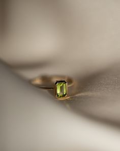 The octagon-shaped peridot on this ring is both eye-catching and elegantly simplistic. It is the perfect way to celebrate a special August birthday or simply adorn oneself with its stunning light green hue. Metrical : 14-karat Yellow Size: Band measures 1mm, Peridot measures 6x4mm Emerald Cut Green Stackable Rings In 14k Gold, 14k Gold Emerald-cut Stackable Rings For May Birthstone, 14k Gold Stackable Emerald-cut Rings For May Birthstone, Green Peridot Birthstone Ring, Dainty Style, Stackable Emerald Cut Green Birthstone Ring, Green Emerald Cut Stackable Birthstone Ring, Green Emerald-cut Stackable Birthstone Ring, Lime Green Peridot Ring For May Birthstone, Lime Green Peridot Birthstone Ring For May