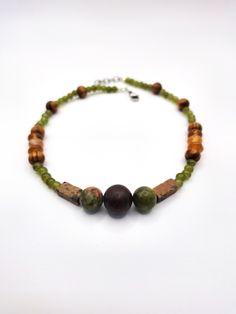 An earthy granola girl aesthetic gemstone choker - crafted with orange carnelian stones, rectangular pink feldspar, with green and pink polished unakite stones and red cherry creek jasper stone at the center.  Accented with green glass beading and natural varnished wood beading. *Handmade by me, one of a kind. *Total Length: 14 inches *Length of Chain: 12.75 inches *Extender Length: 3/4 an inch. If you require a longer extension chain to ensure a proper fit, please let me know!  Just let me know how long you would like your extension chain under personalization instructions. (free of charge) *Diameter of jasper stone: 12 mm *Diameter of unakite stones: 10 mm *Clasp and Chain Material: Lobster claw and jump rings made of stainless steel. *Strung on strong and flexible 19-strand stainless st Whimsigoth Jewelry, Cherry Creek Jasper, Long Extensions, Grunge Hippie, Granola Girl Aesthetic, Orange Carnelian, Pink Polish, Gemstone Choker, Nature Necklace