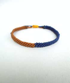 "Brown and Blue Male bracelet, Men's bracelet, boy bracelet, two colour bracelet, surf bracelet Macrame bracelet Boyfriend gift Double color This handknotted bracelet is made with brown and navy blue waxed string. It is adjustable and has a sliding knot closure in order to fit a lot of sizes. Due to its waxed threads,the bracelet is very durable and water resistant. Width: 0.6cm / 0.23\" Other bracelets in my shop: https://www.etsy.com/shop/LuckyRatJewellery?section_id=14498120&ref=shopsection_leftnav_2shopsection_leftnav_2 *Colors may differ slightly from the original due to the configuration of your computer. *There may be light variations on color and size. *Items appear larger on your monitor than actual size. *Please take the time to read the policies of my shop before purchasing an i Blue Waxed Cord Friendship Bracelets With Sliding Knot, Blue Waxed Cord Braided Friendship Bracelets, Blue Waxed Cord Braided Bracelets For Friendship, Casual Blue Macrame Bracelets, Blue Bracelets With Adjustable Waxed Cord, Blue Adjustable Cord Braided Friendship Bracelets, Blue Adjustable Cord Braided Bracelets For Friendship, Blue Waxed Cord Braided Bracelet As Gift, Blue Adjustable Cord Bracelet In Waxed Cord