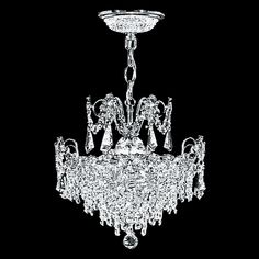 a crystal chandelier hanging from the ceiling in front of a black background,