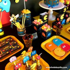 the table is set up with colorful desserts and candies for children's birthday party