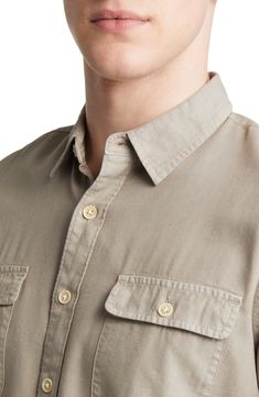 Solid coloring brings easy versatility to a shirt made with a soft cotton blend in a fit that looks great tucked or untucked. Spread collar Short sleeves 60% cotton, 40% rayon Machine wash, dry flat Imported Classic Button-up Camp Shirt For Casual Gatherings, Khaki Collared Shirt With Buttoned Pockets, Casual Solid Short Sleeve Shirt With Placket, Casual Long Sleeve Camp Shirt With Button Closure, Cotton Camp Shirt With Button Closure And Spread Collar, Solid Cotton Camp Shirt With Buttons, Classic Collared Tops With Buttoned Pockets, Casual Collared Shirt With Placket, Everyday Collared Shirt With Roll-up Sleeves