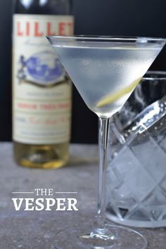 the vesper martini is next to a bottle of booze