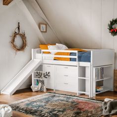 there is a loft bed with stairs and storage space underneath the bed, next to a rug on the floor