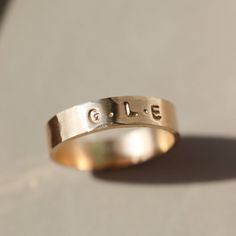 Our Personalized Cigar Band embodies sentimental luxury. Featuring up to six initials, each hand-stamped in small and subtle letters around a hammered band. This ring is a beautiful representation of love, friendships, siblings, or children and stacks seamlessly with other bands and gems. Choose from 14k Gold Fill or Sterling Silver finishes. DETAILS14k gold fill or sterling silver Available in sizes 4-12 (including half sizes) *Please note- we recommend sizing up 1/2-1 size because of the band Hand Stamped 14k Gold Engraved Ring, Heirloom Style Personalized Everyday Rings, Hand Stamped 14k Yellow Gold Engraved Ring, 14k Yellow Gold Hand Stamped Engraved Ring, 14k Yellow Gold Engraved Ring With Hand Stamped Details, Minimalist Engraved Ring With Initials For Promise, Hand Stamped 14k Gold Wedding Rings, Minimalist Hand Stamped Engraved Ring For Anniversary, Meaningful Stamped Jewelry For Promise