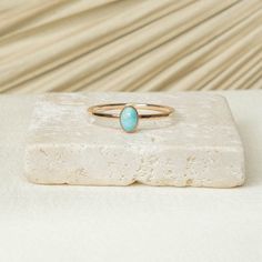 Turquoise Stone has often been associated with protection, luck, and abundance. In many cultures , it is believed that wearing turquoise can ward off negative energies and bring good fortune. Details: 14K Gold Filled + Sterling Silver 6x4mm Turquoise 1.3MM Textured Ring Since every piece is handmade, you may experience a slight color difference in places where the metal has been soldered making every piece truly unique. Purchase three or more rings and save 20% with discount code 'STACK20' Oval Turquoise Birthstone Ring, Turquoise Opal Ring In 14k Gold As Gift, Oval Stackable Turquoise Ring Gift, Oval Turquoise Stackable Ring As Gift, Oval Stackable Turquoise Ring As Gift, Minimalist Turquoise Oval Ring, Oval Turquoise Ring With Natural Stones In Sterling Silver, 14k Gold Turquoise Oval Cabochon Ring Gift, Elegant Oval Nickel-free Turquoise Ring