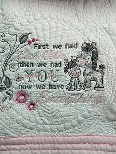 a pink quilted pillow with an image of a horse on it's back