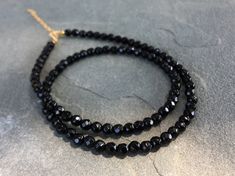 Black Onyx Beaded Necklace, Black Onyx Choker Necklace DETAILS - 4mm Black Onyx Beads - 14K Gold Filled Spring Ring Clasp 5mm - 14K Gold Filled 2 inches Extender Chain - Necklace Length 14 - 16 inches Please note: Because we use natural stones, the stones may vary slightly in shape, shade and size. They may also contain natural inclusions. If you have any questions, please feel free to contact me. This natural black onyx necklace is made with small faceted sparkling black gemstone beads to creat Black Onyx Round Bead Crystal Necklaces, Black Crystal Necklaces With Round Gemstone Beads, Black Onyx Round Beads Crystal Necklace, Black Onyx Round Beads Necklace, Black Rondelle Beaded Necklaces, Black Single Strand Beads For Jewelry Making, Black Rondelle Gemstone Bead Necklace, Black Onyx Beaded Necklace With Faceted Beads, Black Beaded Rondelle Necklace