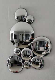 several mirrors are hanging on the wall