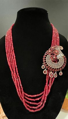 This necklace is a statement piece with a beautiful red/magenta shade and comes with a matching pair of earrings. The length can be adjusted accordingly. Elegant Red Beaded Jewelry Set, Red Party Jewelry With Jewels, Red Long Necklace For Party, Pink Ruby Necklace For Formal Occasions, Red Bridal Necklace For Party, Red Costume Jewelry Necklaces For Party, Formal Pink Ruby Necklace, Red Pendant Jewelry For Formal Occasions, Elegant Red Beaded Jewelry