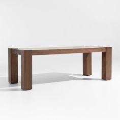 a long wooden table sitting on top of a white floor