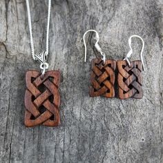 "This beautiful and unique hand-carved wooden Celtic knot jewelry set will be made for you, or a loved one, in my studio on the West of Ireland. These dainty rosewood Celtic necklace & earrings are recycled from musical instruments constructed by a local luthier. As a musician myself, I take enormous satisfaction in creating a jewelry set whose inherent wood has previously featured in a beautiful hand-made guitar. Also, part of rosewood's attractiveness is its durability and ability to stand Traditional Brown Carved Jewelry, Handmade Wooden Pendant Jewelry, Handmade Mahogany Jewelry Gift, Handmade Mahogany Jewelry For Gift, Mahogany Handmade Jewelry For Gift, Handmade Artisan Mahogany Jewelry, Unique Mahogany Jewelry For Gift, Artisan Handmade Mahogany Jewelry, Rustic Brown Engraved Jewelry