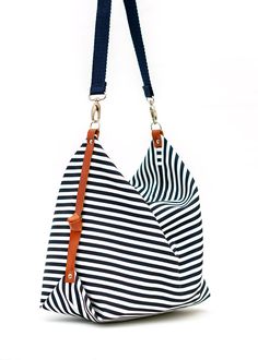 "The Marina diaper bag has been designed for your everyday life, able to carry anything you may need during your daily activities The bag is made from a cotton canvas, in a nice navy blue and white striped pattern and has leather details at the sides, which provides a very nice shape. It closes with a zipper and it is fully lined with a cotton canvas, with the color of your choice (yellow or light grey). This Marina diaper bag has one strap, made from a thick cotton twill in navy blue color, whi Navy Cotton Shoulder Bag For Everyday Use, Canvas Bags With Striped Lining For Everyday Use, Everyday Use Canvas Tote Bag With Striped Lining, White Bag With Striped Lining For Everyday Use, White Travel Bag With Striped Lining, Everyday Tote Canvas Bag With Striped Lining, White Nautical Bag For Everyday, Striped Cotton Shoulder Bag For Daily Use, Striped Bag With Leather Handles For Everyday Use