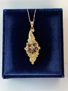 "Beautiful antique circa 1880s Victorian era 14k yellow gold genuine garnet and seed pearl flower brooch conversion pendant! This pendant contains five marquise cut genuine garnets with an estimated 0.7 ctw in a flower shape with four seed pearls in the center. It's shown modeled on a 14k yellow gold new 18\" chain. A wonderful piece of fine antique jewelry, that is ready to be worn! ERA - Circa 1880s - Victorian Era METAL / MATERIAL - 14k yellow gold,4 seed pearls, 5 genuine garnets ( approx. 0.7 ctw) MARKINGS / HISTORY - Both pendant and necklace stamped \"14k\"  CONDITION - Good antique condition. Yellow gold metal has been professionally polished & cleaned. Amazing antique conversion pendant necklace !  SIZE / MEASUREMENTS - Chain Modeled: 14k Yellow Gold 18 inches, Pendant: 2 x 3/4  i Victorian Hallmarked Jewelry For Opera, Victorian Baroque Formal Jewelry, Antique Formal Jewelry With Flower Pendant, Antique Flower Pendant Jewelry For Formal Occasions, Heirloom Style Formal Necklace With Brooch, Antique Pendant Jewelry For Opera, Victorian Pendant Jewelry For Opera, Victorian Baroque Yellow Gold Jewelry, Victorian Marquise Gemstone Jewelry