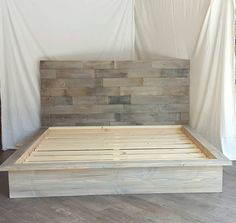 a bed frame made out of wooden planks