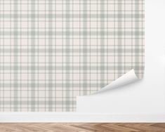 an empty room with a white wall and plaid pattern on the wall, as well as a roll of paper