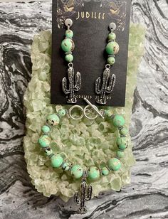 Embrace the beauty of the Southwest with this exquisite handcrafted jewelry set by Jubilee. The set features a charming pair of earrings and a matching bracelet, both adorned with turquoise beads and unique cactus charms. **Earrings - Length: Approximately 2 inches - Turquoise beads with natural brown veining - Silver-toned cactus charms - Secure post-back closures **Bracelet - Adjustable length with a toggle clasp - Turquoise beads with natural brown veining - Silver-toned cactus charm centerpi Charms Earrings, Matching Bracelet, Tucson Az, Bohemian Clothes, Matching Bracelets, Natural Brown, Toggle Clasp, Turquoise Beads, Earthy Tones