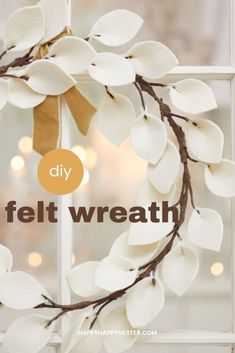 a wreath made out of white paper with the words diy felt wreath