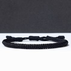 "◾ The handmade black Tibetan bracelet for luck and protection is a beautifully crafted accessory, each knot is meticulously tied whos creates an amazing pattern. ✅ Adjustable bracelet - the slip knot lets you adjust the size. ➰ Sizes: S - Fully Closed - 5.9\"inches (15cm) / Full Opened - 9.8\"inches (25cm) M - Fully Closed - 6.6\"inches (17cm) / Full Opened - 10.6\"inches (27cm) L - Fully Closed - 7.4\"inches (19cm) / Full Opened - 11.4\"inches (29cm) ⬛ The color of the bracelet is black. ◽ More colors and models are available in the shop. ◽ Just check out the shop. ✔️ Please note that due to the difference between different monitors, the image may not reflect the actual color of the item. ✍ If you have any questions please contact me." Black Woven Bracelet Gift, Handmade Black Nylon Cord Bracelets, Black Minimalist Beaded Bracelet With Adjustable Cord, Handmade Black Braided Bracelets For Beach, Everyday Black Bracelets With Nylon Cord, Casual Braided Bracelets With Sliding Knot, Black Nylon Cord Braided Bracelet For Everyday, Adjustable Nylon Cord Braided Bracelets For Everyday, Casual Black Braided Bracelets For Friendship