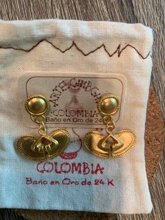 Throughout generations of my Colombian family till this day, we have threaded each bead and shaped every earring into beautiful artisan PreColombian jewelry. Every piece is inspired by at least one part of Colombia's precious nature. Handwoven Brass Dangle Earrings, Handwoven Dangle Brass Earrings, Gold Handwoven Drop Earrings, Handwoven Gold Drop Earrings, Traditional Fair Trade Jewelry Gift, Traditional Fair Trade Jewelry As A Gift, Nickel-free Traditional Gold-plated Earrings, Handwoven Brass Earrings For Gift, Artisan Gold Plug Earrings Nickel Free