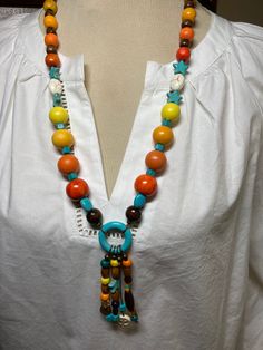 A single strand with pendant.  Another necklace that remind me of Aztec  culture.  A fun and multi colored necklace. Multicolor Adjustable Lariat Necklace, Unique Multicolor Wooden Beads Necklaces, Bohemian Multicolor Wooden Bead Necklaces, Multicolor Bohemian Necklace With Wooden Beads, Bohemian Multicolor Wooden Beads Necklace, Bohemian Multicolor Long Necklace, Adjustable Multicolor Beaded Dangle Necklaces, Unique Multicolor Necklaces For The Beach, Multicolor Long Necklace For Summer