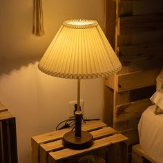 a lamp that is sitting on top of a wooden table next to a night stand