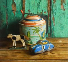 a painting of a toy car next to a teapot and cow figurine